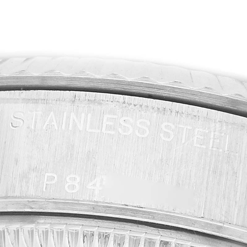 The image shows a close-up of the stainless steel casing of a Rolex Datejust 79174 Women's Stainless Steel Silver Dial watch, highlighting the engraved text.