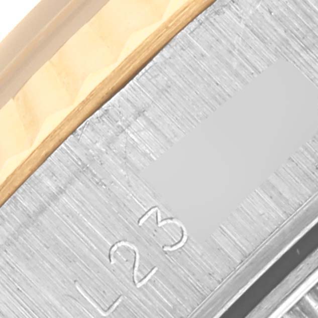 The image shows a close-up of the side of a Rolex Datejust 69173 Women's Steel and Gold (two tone) Black Dial 69173 Women's Steel and Gold (two tone) Black Dial, highlighting the edge of the bezel with some engraved details.