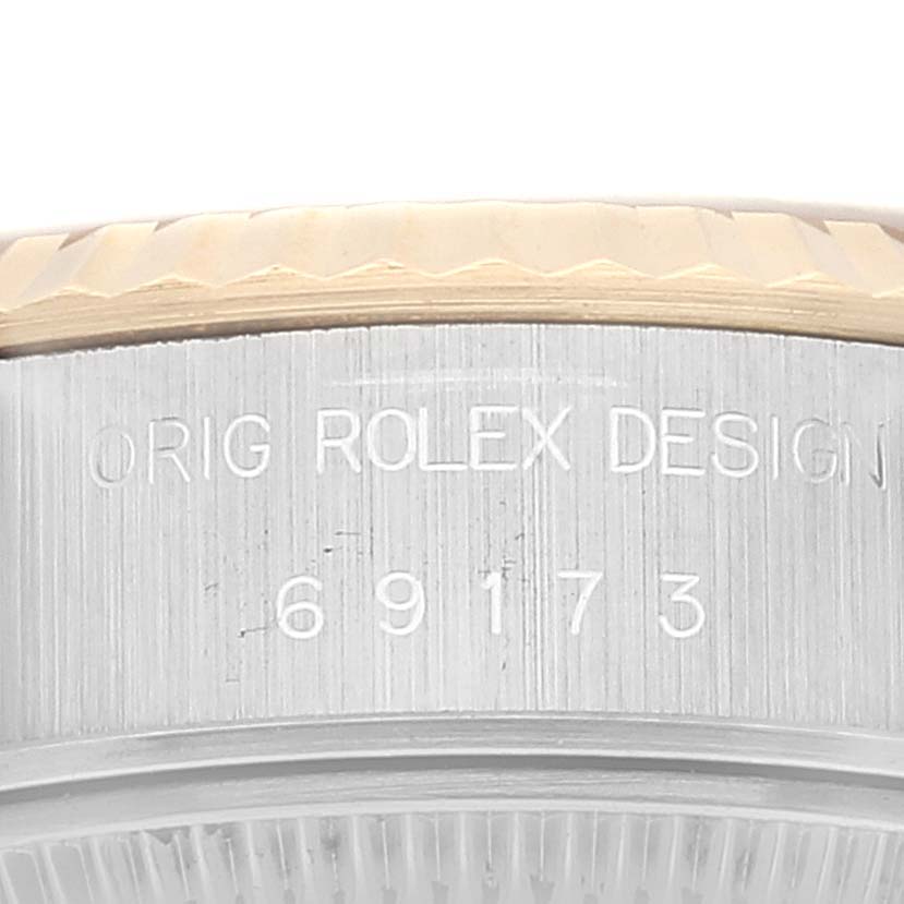 This is a close-up of the side of a Rolex Datejust 69173 Women's Steel and Gold (two tone) Champagne Dial 69173 Women's Steel and Gold (two tone) Champagne Dial watch showcasing the model number and design engraving.