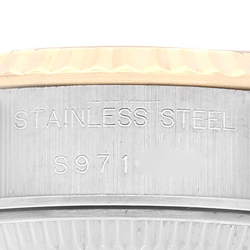 The image shows a close-up angle of the case side of the Rolex Datejust 69173 Women's Steel and Gold (two tone) Champagne Dial 69173 Women's Steel and Gold (two tone) Champagne Dial watch, highlighting the "STAINLESS STEEL" engraving and a partial serial number.