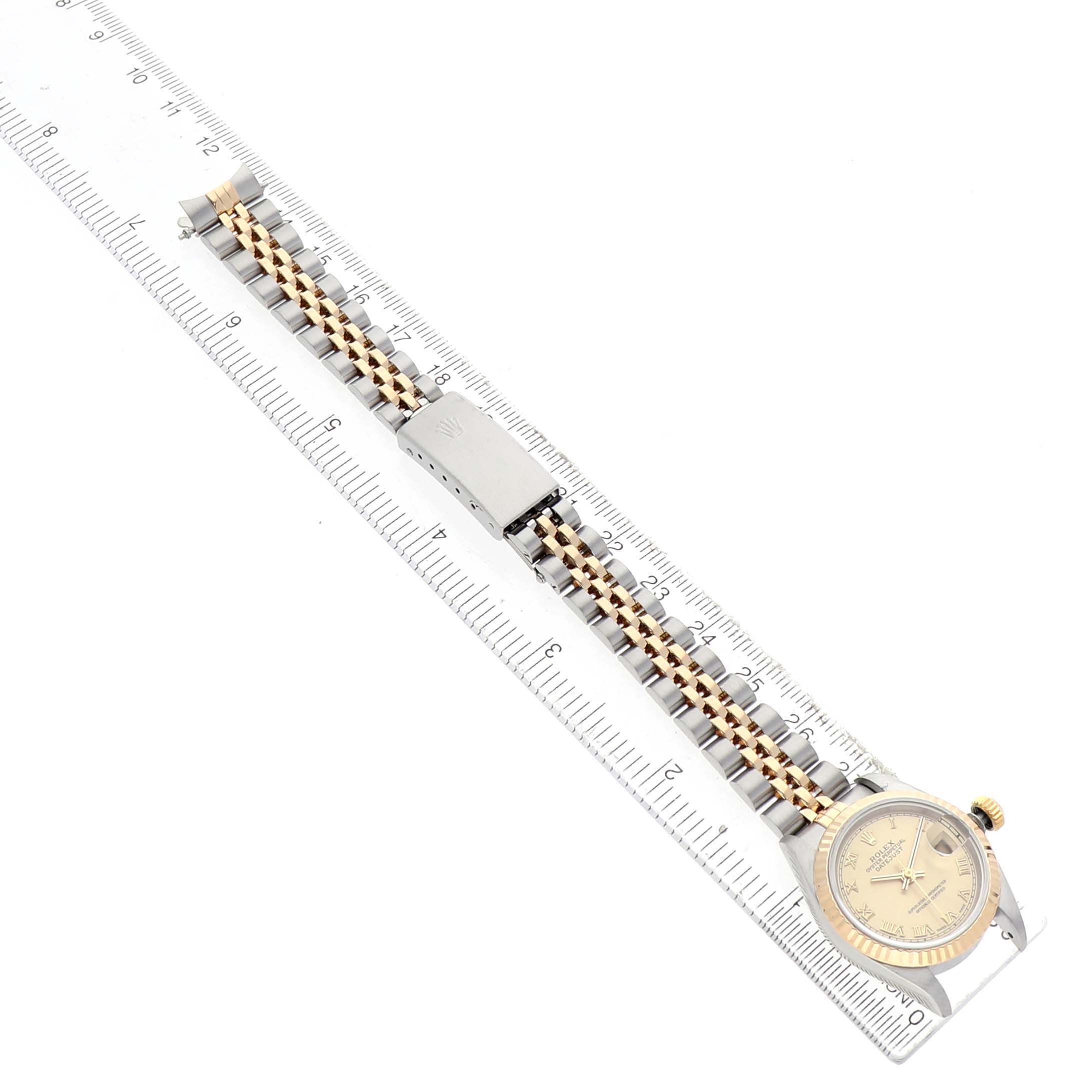 The image shows a Rolex Datejust 69173 Women's Steel and Gold (two tone) Champagne Dial watch laid flat, displaying the bracelet with a clasp and ruler for scale.