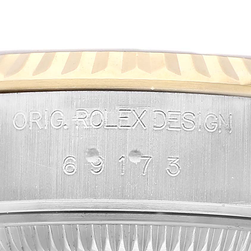 The image shows a close-up of the side engraving on the case of a Rolex Datejust 69173 Women's Steel and Gold (two tone) Champagne Dial watch.