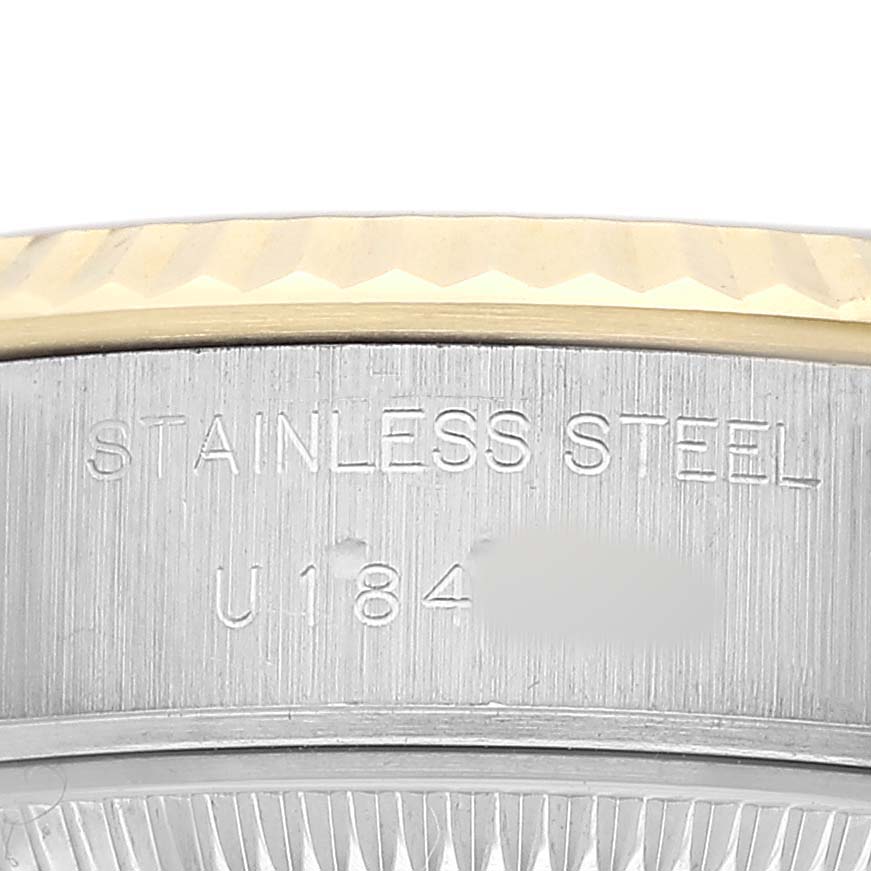 The image shows a close-up of the engraved stainless steel part of the Rolex Datejust 69173 Women's Steel and Gold (two tone) Champagne Dial watch case.