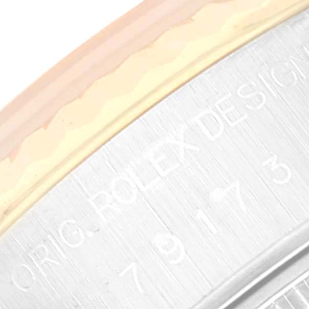 This is a close-up of the engraved side of a Rolex Datejust 79173 Women's Steel and Gold (two tone) Champagne Dial 79173 Women's Steel and Gold (two tone) Champagne Dial watch case.