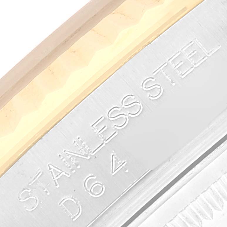 This close-up image of a Rolex Datejust 116233 Men's Steel and Gold (two tone) Silver Dial 116233 Men's Steel and Gold (two tone) Silver Dial watch shows the stainless steel area near the bezel with engraved text.
