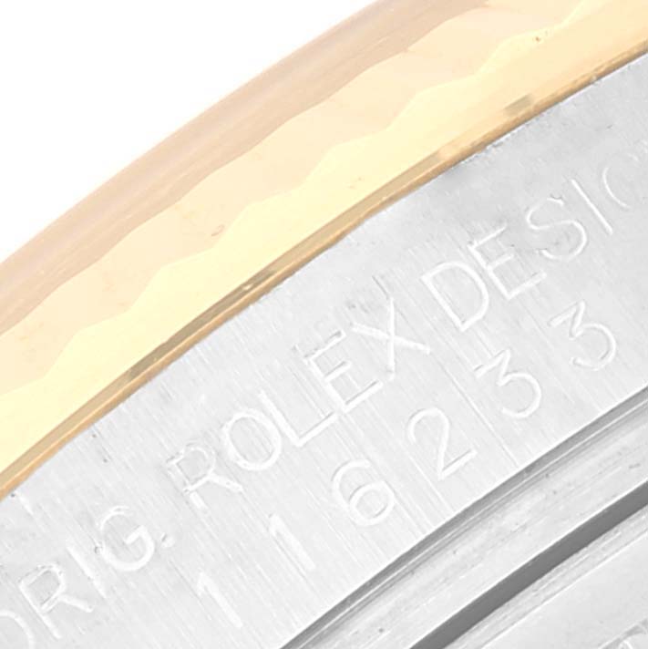 This image shows a close-up of the bezel and engraved serial number area on a Rolex Datejust 116233 Men's Steel and Gold (two tone) Silver Dial 116233 Men's Steel and Gold (two tone) Silver Dial watch.
