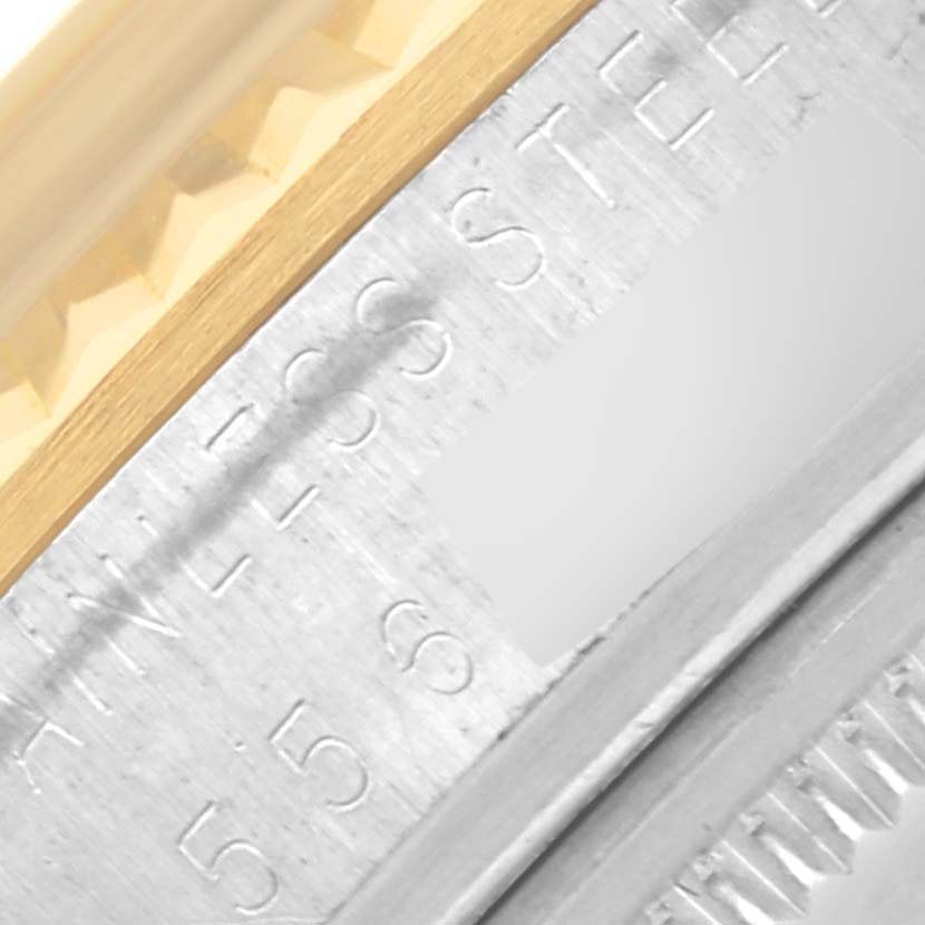 The image shows a close-up of the edge of a Rolex Datejust 16013 Men's Steel and Gold (two tone) Champagne Dial 16013 Men's Steel and Gold (two tone) Champagne Dial watch, focusing on the gold fluted bezel and part of the stainless steel case.