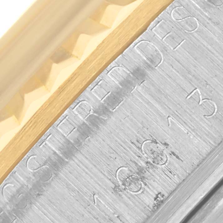 The image shows a close-up of the bezel and engraved edge of a Rolex Datejust 16013 Men's Steel and Gold (two tone) Champagne Dial 16013 Men's Steel and Gold (two tone) Champagne Dial watch, highlighting the gold and silver tones.