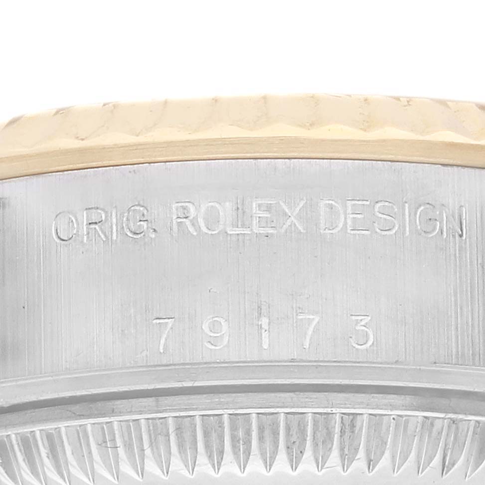 The image shows the side view of the Rolex Datejust 79173 Women's Steel and Gold (two tone) Champagne Dial 79173 Women's Steel and Gold (two tone) Champagne Dial, highlighting the engraved model number on the case.