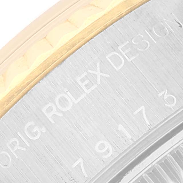 The image shows a close-up of the side of the watch case and part of the bezel of a Rolex Datejust 79173 Women's Steel and Gold (two tone) Silver Dial 79173 Women's Steel and Gold (two tone) Silver Dial.