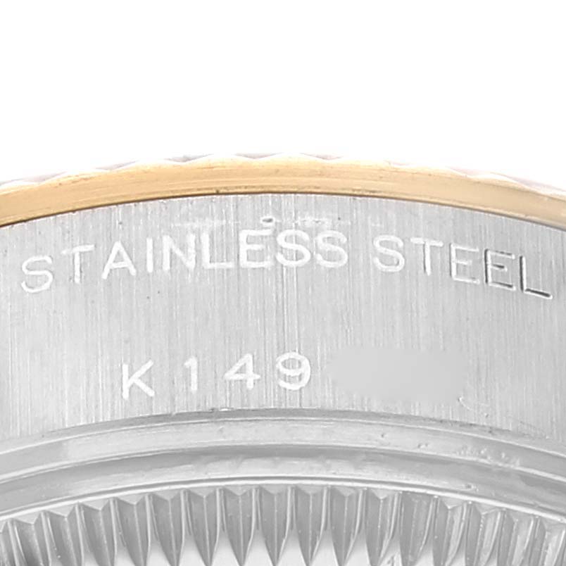 This is a close-up showing the bezel and case of a Rolex Datejust 79173 Women's Steel and Gold (two tone) Grey Dial 79173 Women's Steel and Gold (two tone) Grey Dial model with "STAINLESS STEEL" and a partial serial number engraved.