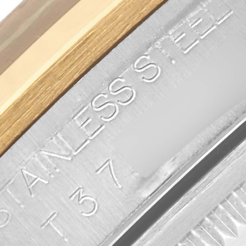 The image shows a close-up of the Rolex Datejust 16203 Men's Steel and Gold (two tone) Grey Dial 16203 Men's Steel and Gold (two tone) Grey Dial case side, focusing on the stainless steel part with engraving.