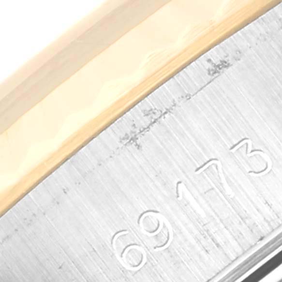 This image shows a close-up of the serial number and bezel on a Rolex Datejust 69173 Women's Steel and Gold (two tone) Champagne Dial 69173 Women's Steel and Gold (two tone) Champagne Dial watch.