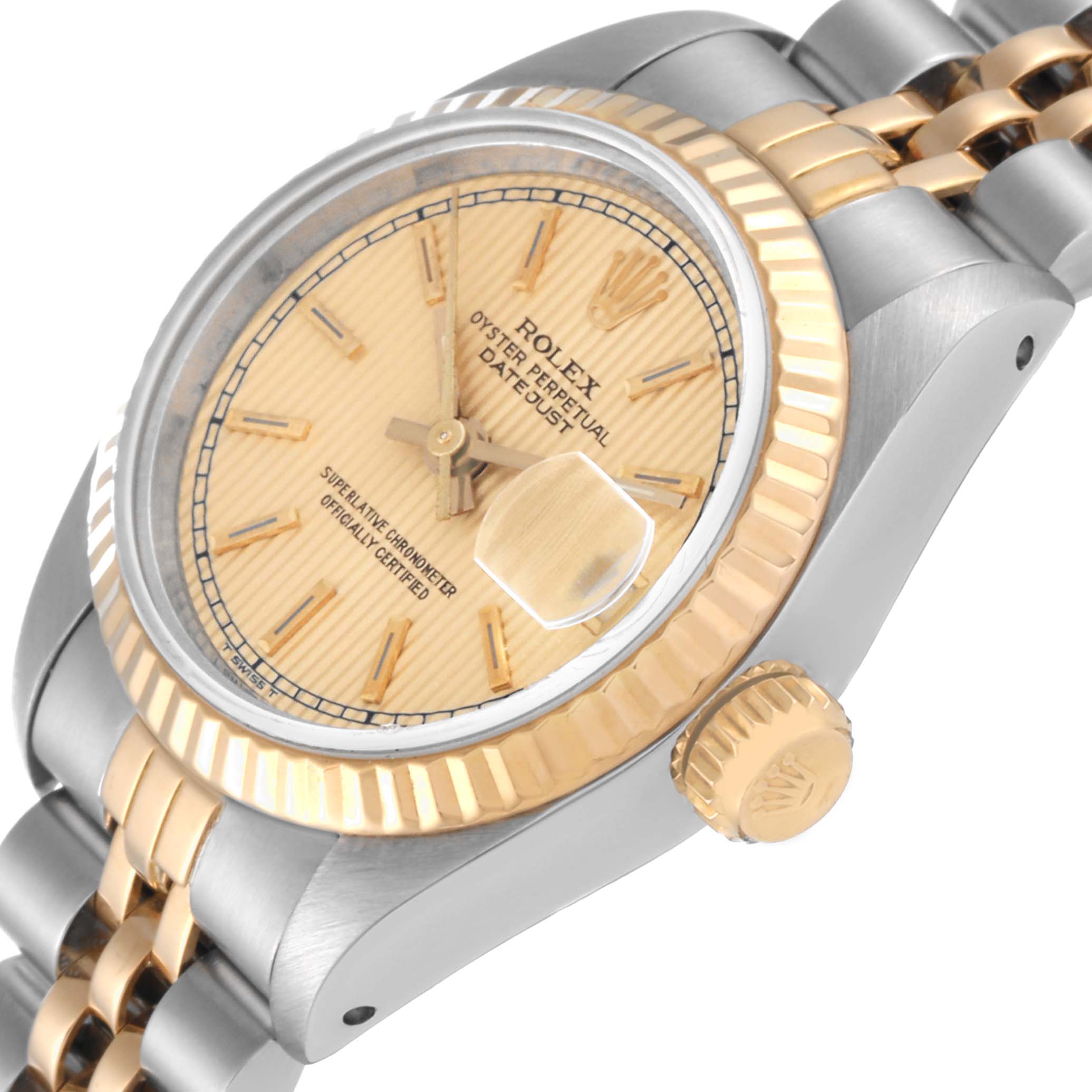 The image shows a close-up angle of the Rolex Datejust 69173 Women's Steel and Gold (two tone) Champagne Dial 69173 Women's Steel and Gold (two tone) Champagne Dial watch highlighting its dial, fluted bezel, crown, and part of the bracelet.