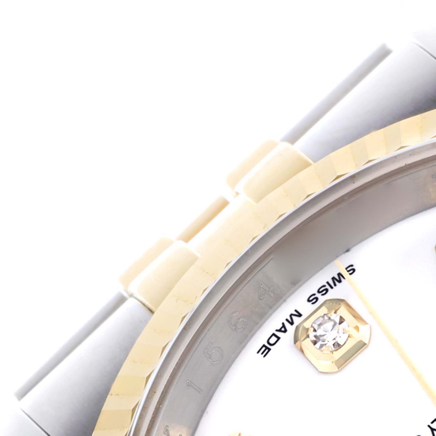 The image shows a close-up of the Rolex Datejust 116233 Men's Steel and Gold (two tone) White Dial 116233 Men's Steel and Gold (two tone) White Dial watch, highlighting the bezel, part of the bracelet, and a diamond hour marker.