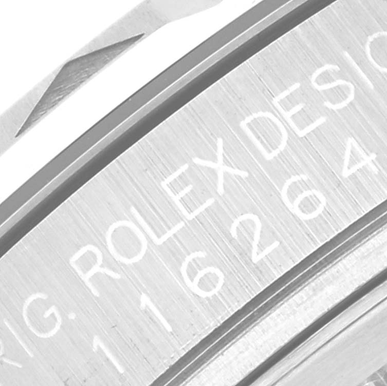 This image shows a close-up of the engraved serial number and "Rolex Design" text on the casing of a Rolex Turn-o-Graph 116264 Men
s Stainless Steel Blue Dial 116264 Men
s Stainless Steel Blue Dial watch.