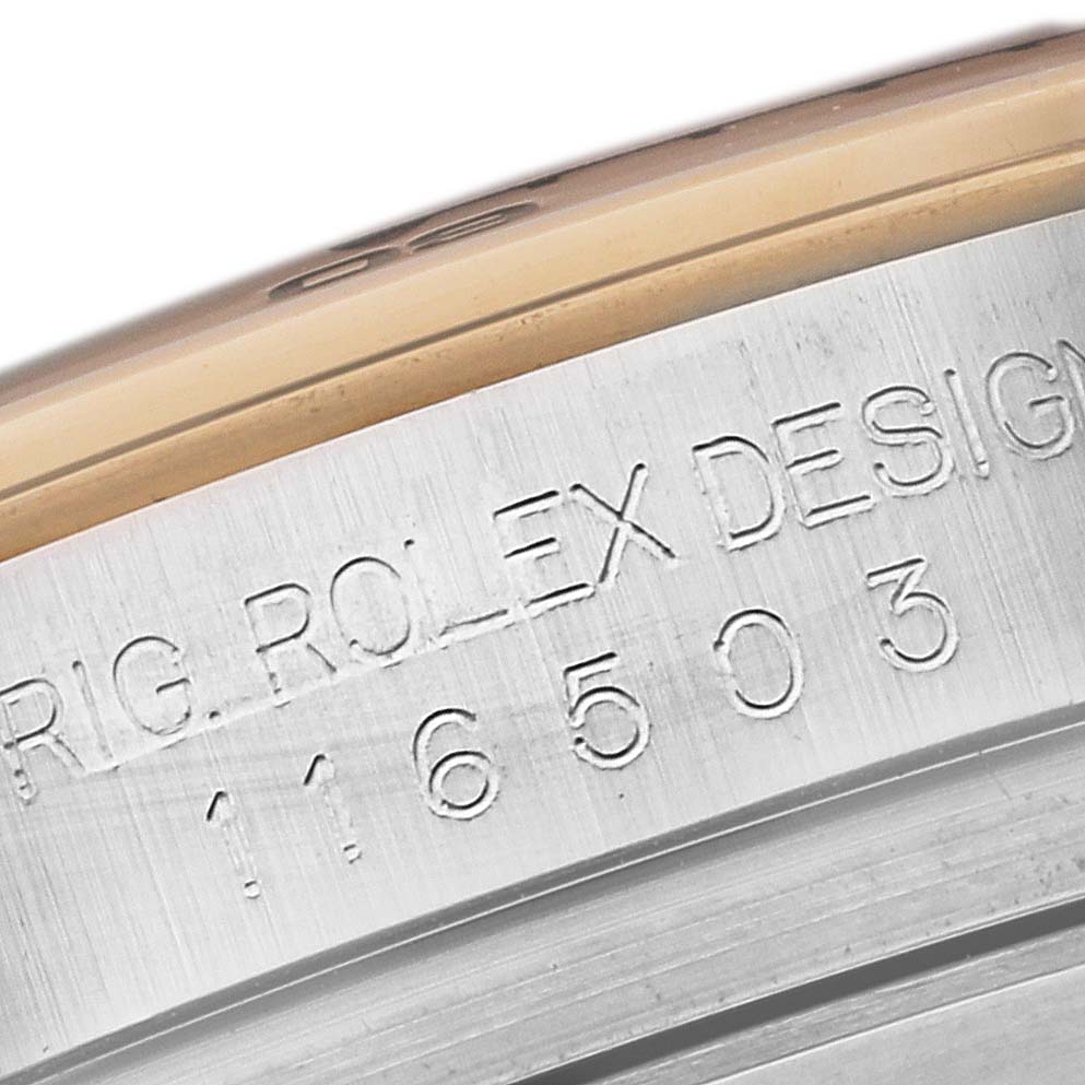 This image shows a close-up of the case side of a Rolex Daytona 116503 Men's Steel and Gold (two tone) Champagne Dial 116503 Men's Steel and Gold (two tone) Champagne Dial watch, displaying engraved text and model number 116503.