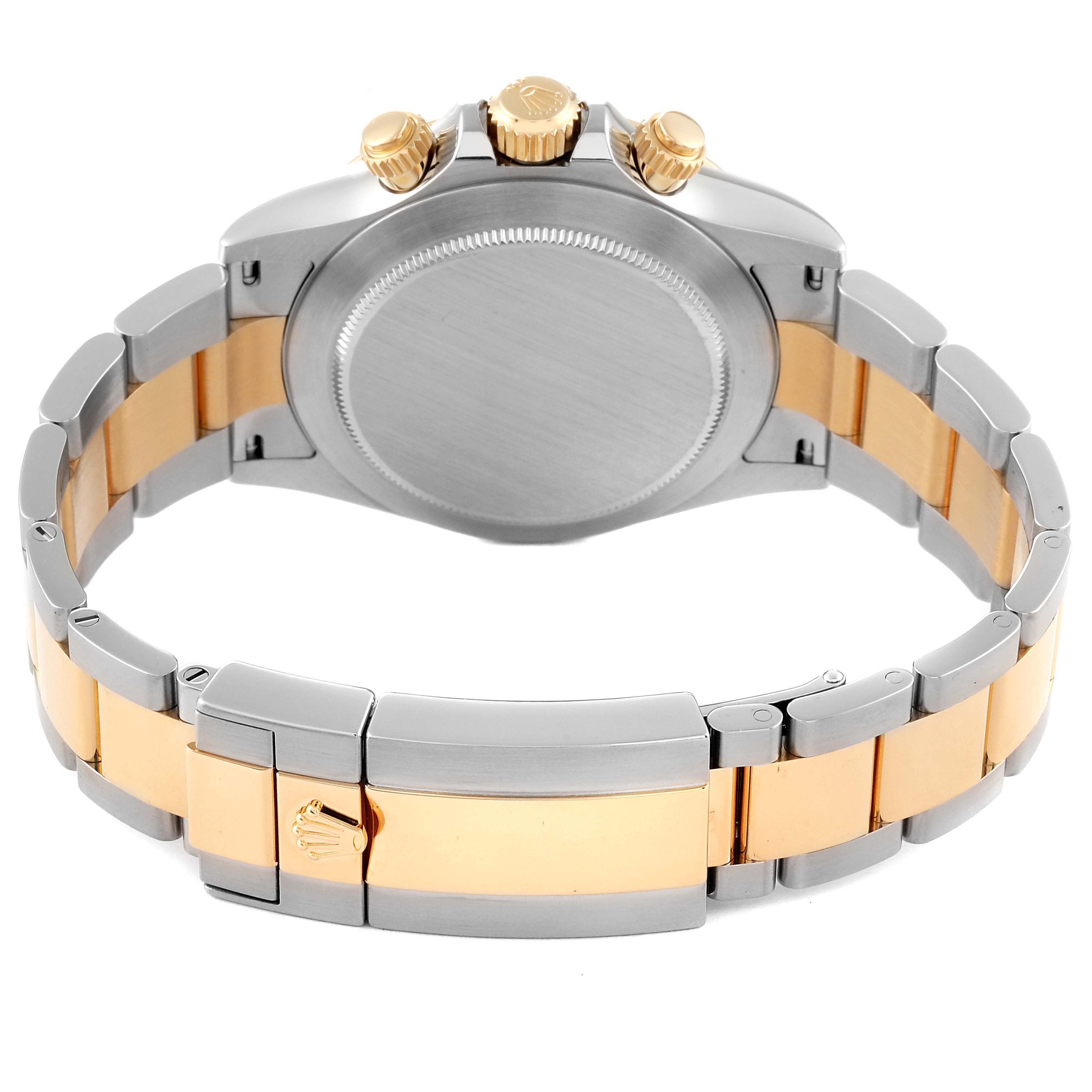 The image shows the back and clasp of a two-tone Rolex Daytona 116503 Men's Steel and Gold (two tone) Champagne Dial 116503 Men's Steel and Gold (two tone) Champagne Dial watch, featuring stainless steel and gold elements.