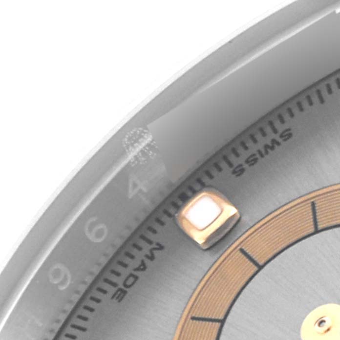 The image shows a close-up angle of the Rolex Daytona 116523 Men's Steel and Gold (two tone) Grey Dial 116523 Men's Steel and Gold (two tone) Grey Dial's dial, focusing on the edge with markers and "Swiss Made" text.