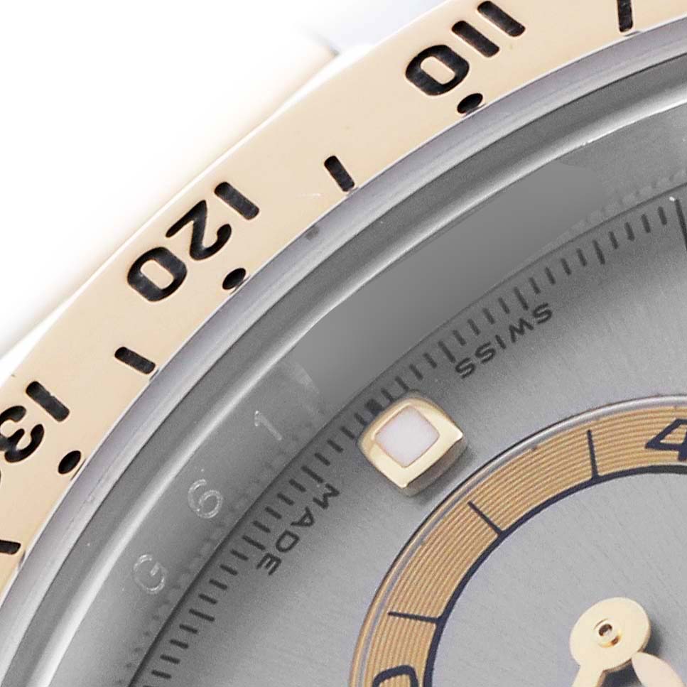 The image shows a close-up of the bezel and part of the dial of a Rolex Daytona 116523 Men's Steel and Gold (two tone) Grey Dial 116523 Men's Steel and Gold (two tone) Grey Dial watch, highlighting the numbers and markers.