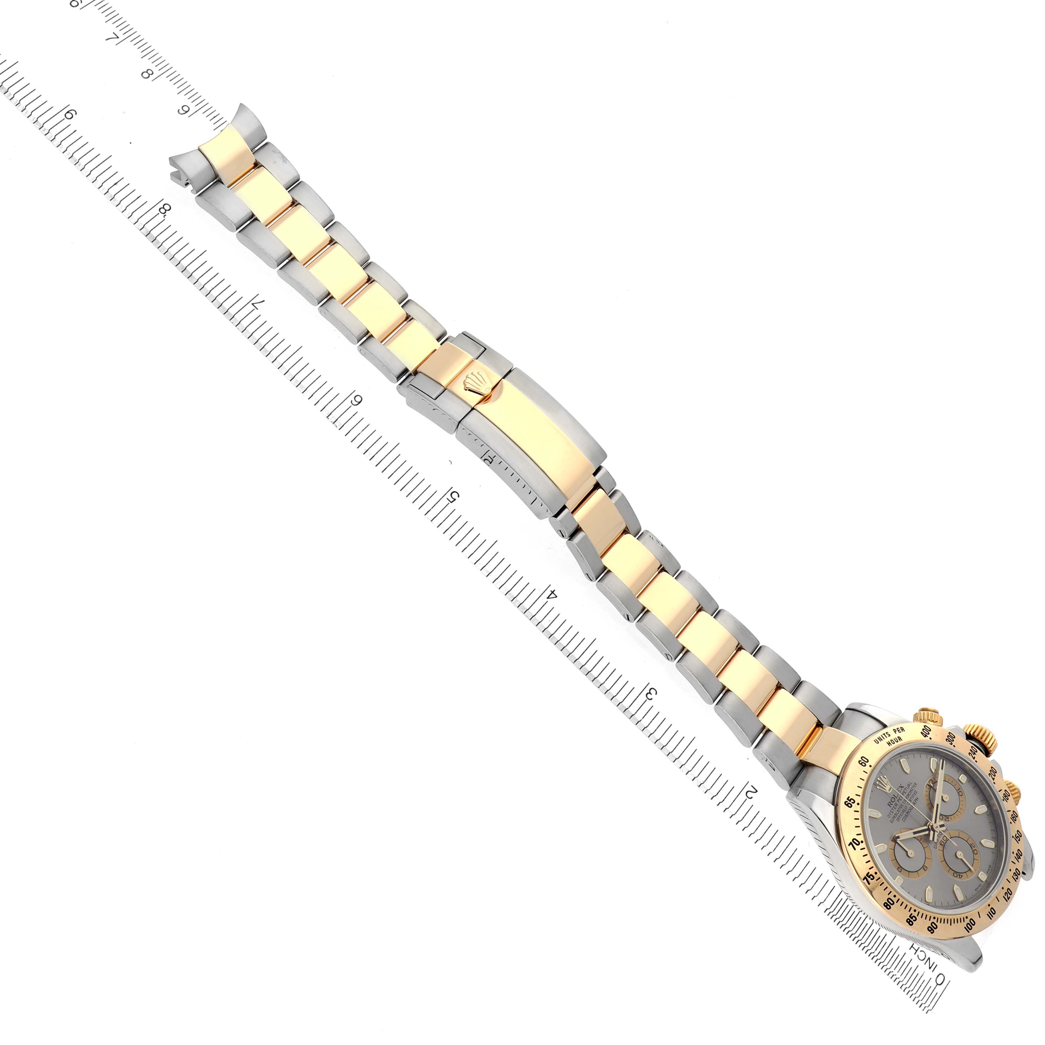 The image shows a top-down view of a Rolex Daytona 116523 Men's Steel and Gold (two tone) Grey Dial 116523 Men's Steel and Gold (two tone) Grey Dial watch, highlighting the bracelet with gold and silver links and the face at the right.