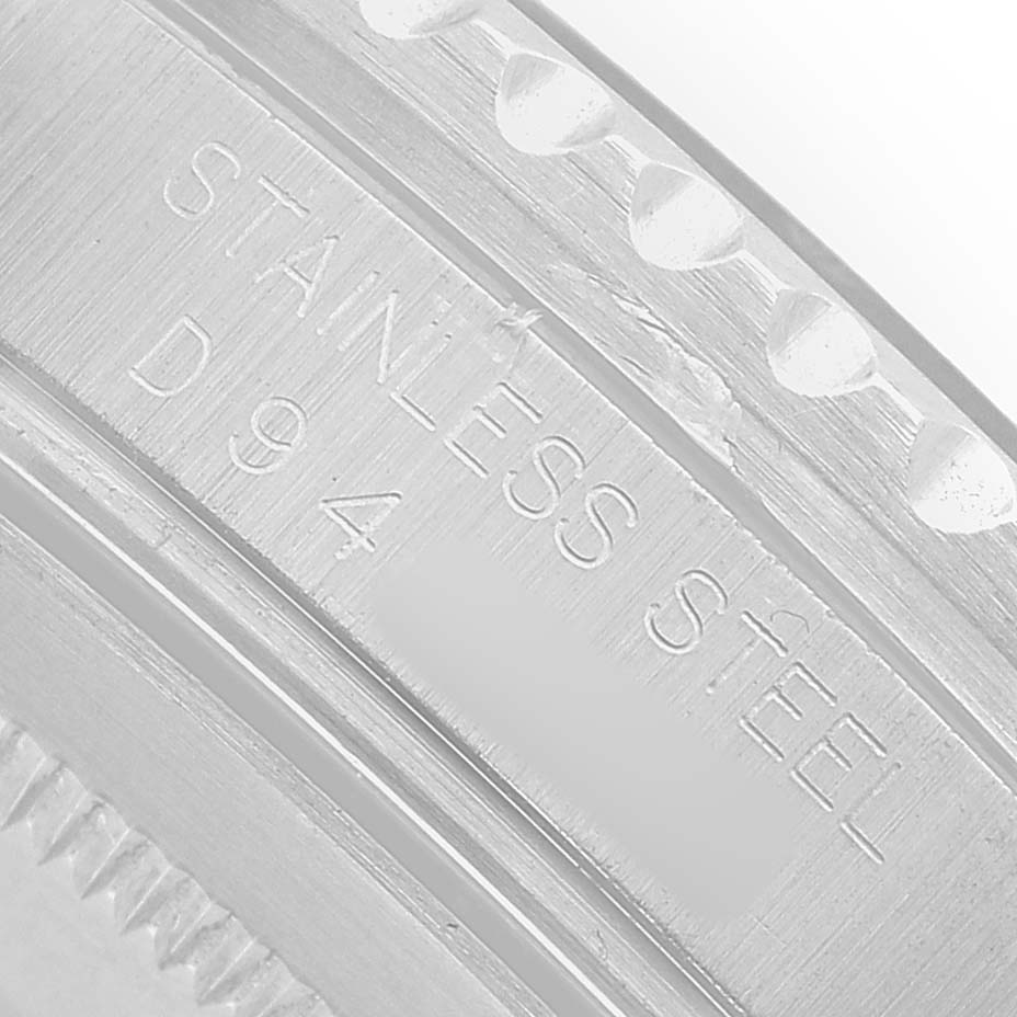 The image shows a close-up of the stainless steel bezel edge of a Rolex GMT-Master 16710 Men's Stainless Steel Black Dial watch.