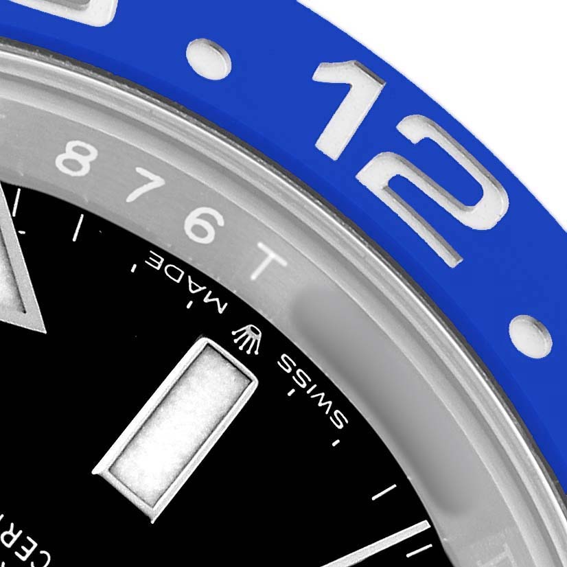 The image shows a close-up of the blue bezel and part of the dial of a Rolex GMT-Master 126710BLNR Men's Stainless Steel Black Dial watch, focusing on the 12 o'clock marker.