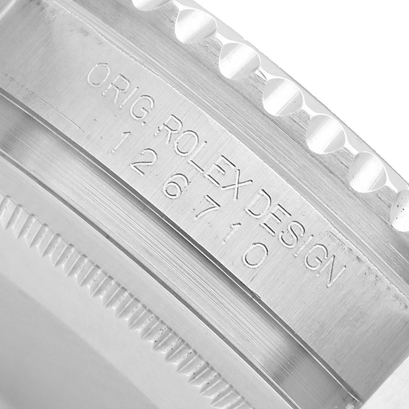 The image shows a close-up of the case side, bezel edge, and engraved design details of the Rolex GMT-Master 126710BLNR Men's Stainless Steel Black Dial.