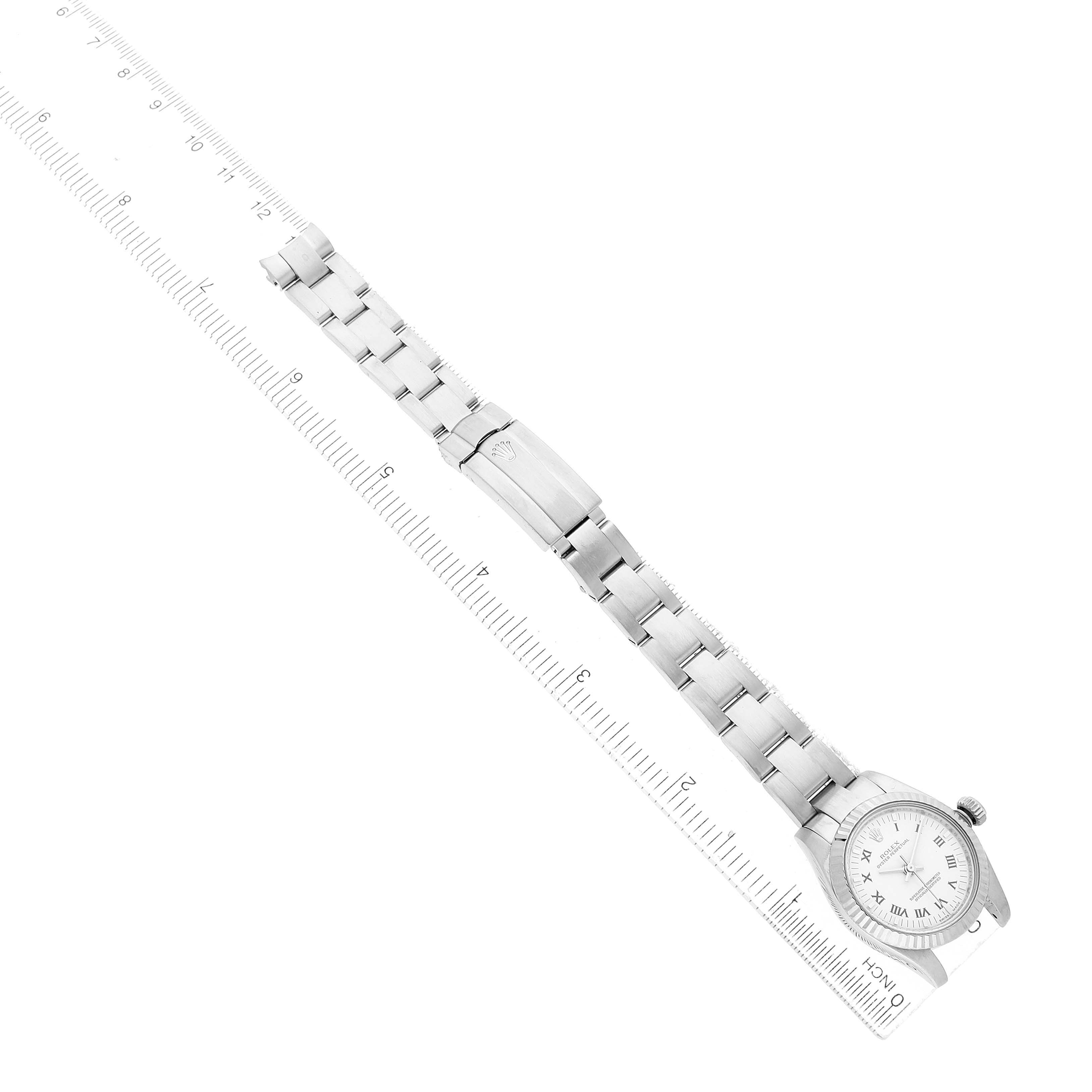 The Rolex Oyster Perpetual 176234 Women's Stainless Steel White Dial watch is shown from a top-down angle, highlighting the face, bracelet, and clasp next to a ruler for scale.