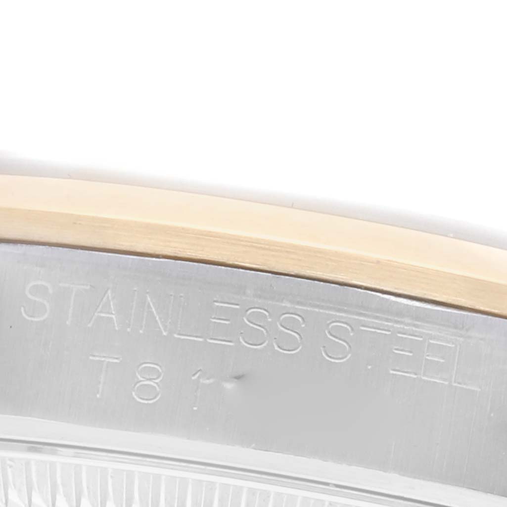 The image shows a close-up of the side of a Rolex Datejust, displaying the "Stainless Steel" engraving.