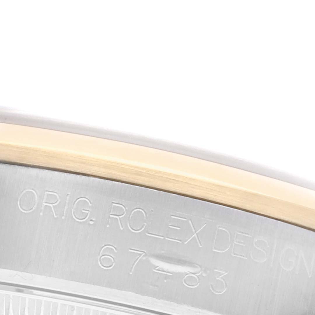 The image shows a close-up of the side of a Rolex Datejust, highlighting engraving details on the watch's case.