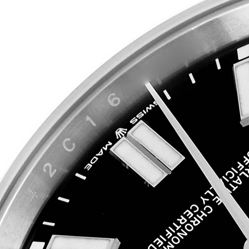 The image shows a close-up of the dial and bezel of a Rolex Oyster Perpetual 124300 Men
s Stainless Steel Black Dial 124300 Men
s Stainless Steel Black Dial watch, highlighting a section of the hour markers and minute indices.