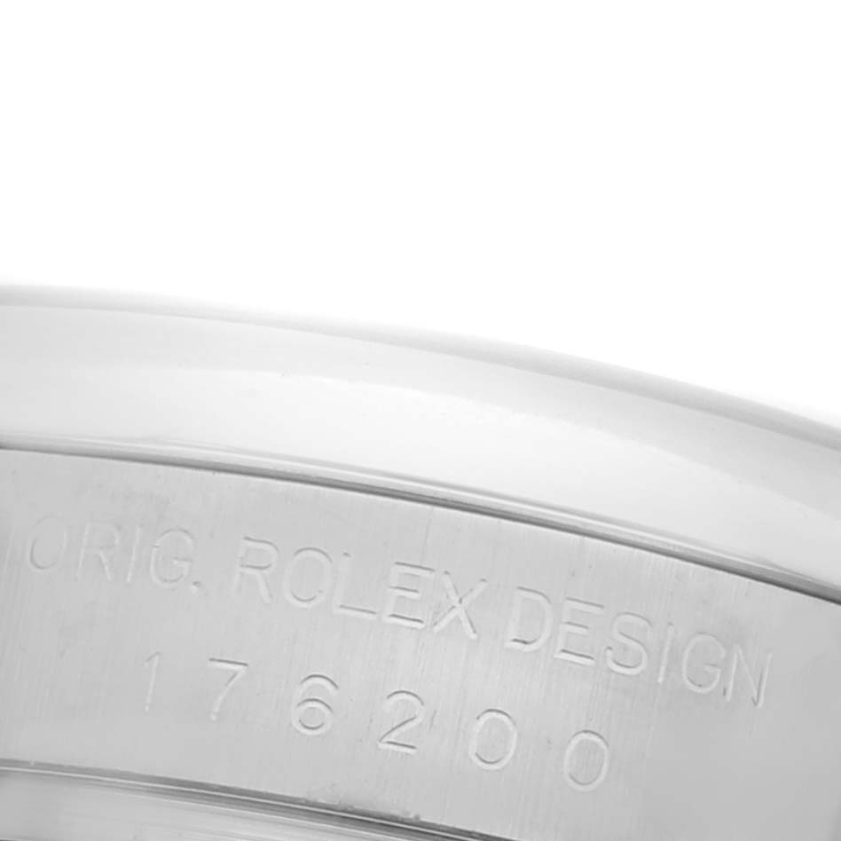 The image shows a close-up of the side of the Rolex Oyster Perpetual 176200 Women's Stainless Steel White Dial 176200 Women's Stainless Steel White Dial, highlighting the engraved design details.