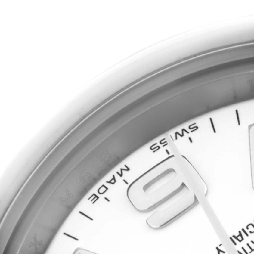 The image shows a close-up of the Oyster Perpetual Rolex watch, highlighting part of the dial and the number "9".