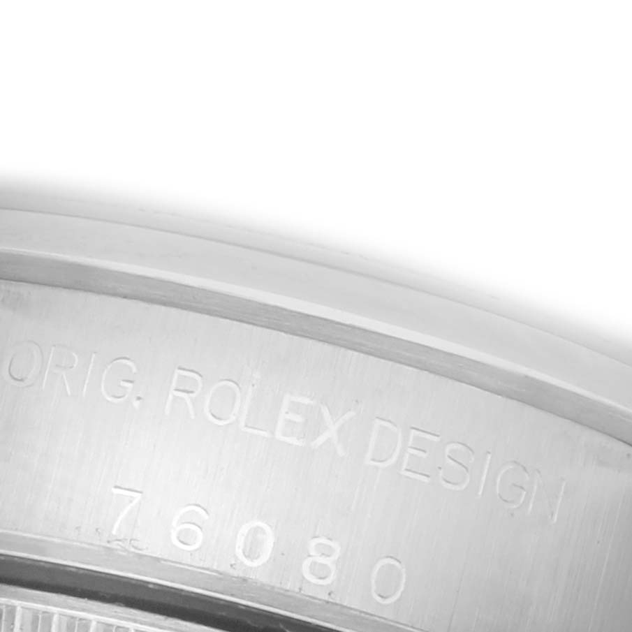 The image shows the engravings on the side of the case of a Rolex Oyster Perpetual 76080 Women's Stainless Steel Pink Dial 76080 Women's Stainless Steel Pink Dial watch.