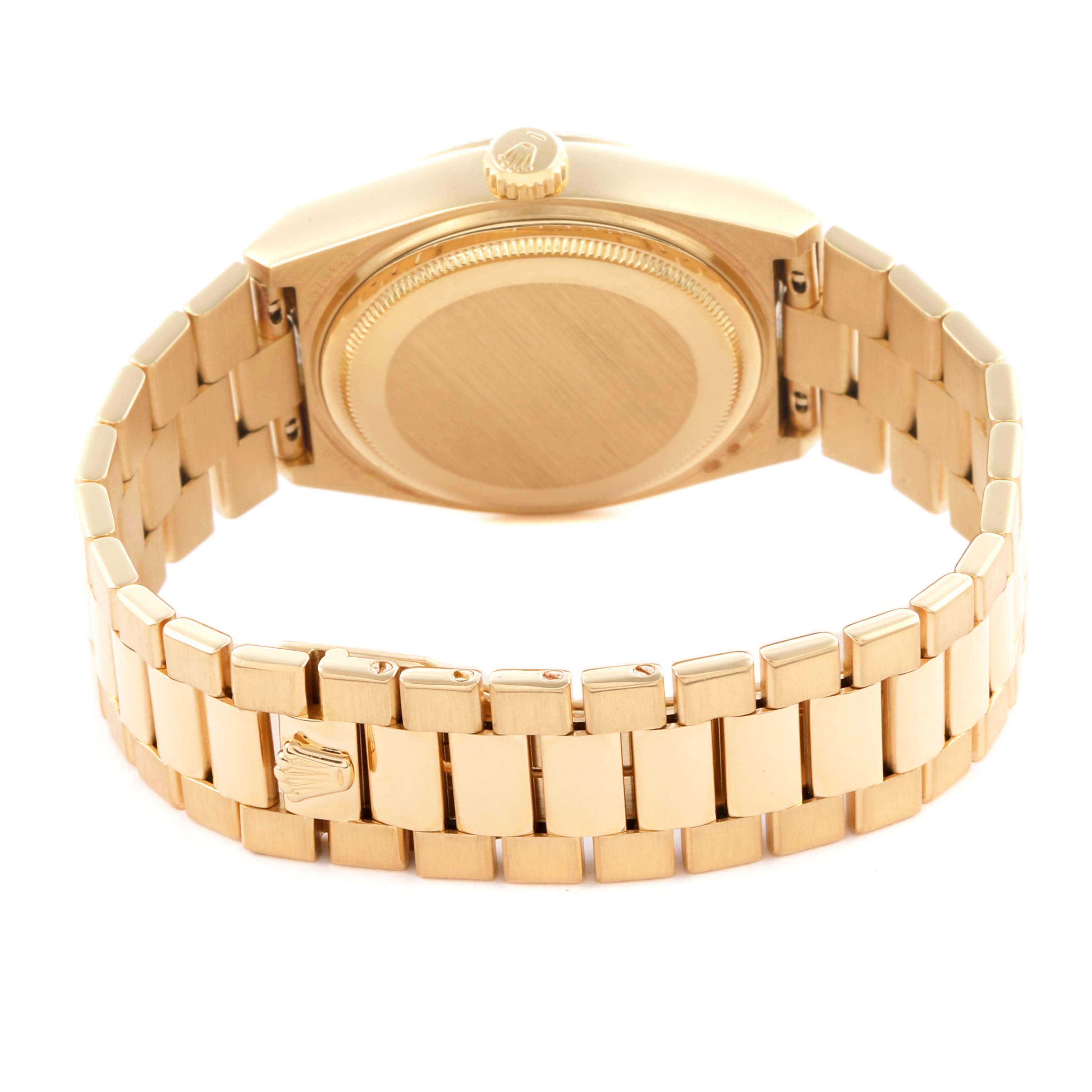 The image shows the back and bracelet of a Rolex Oysterquartz watch from a slightly elevated rear angle.