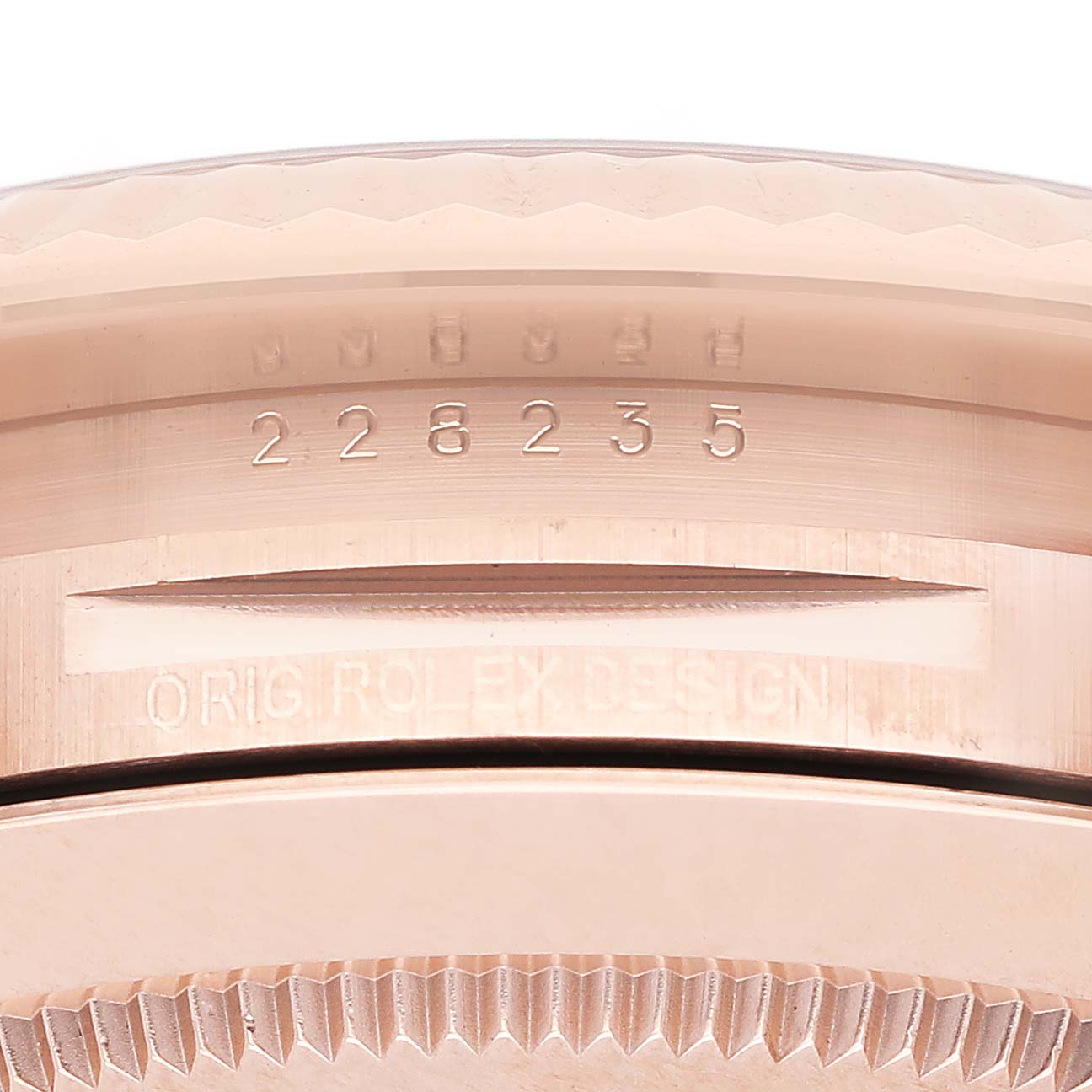 The image shows a close-up of the Rolex President 228235 Men's Rose Gold Mother of Pearl Dial model's engraved case back and edge details.