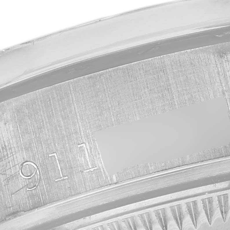 The image shows a close-up of the Rolex President 69159 Women's White Gold Silver Dial 69159 Women's White Gold Silver Dial model's inner bezel with engravings.