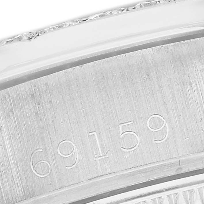 The image shows a close-up of the serial number engraving on the inner bezel of a Rolex President 69159 Women's White Gold Silver Dial 69159 Women's White Gold Silver Dial model watch.