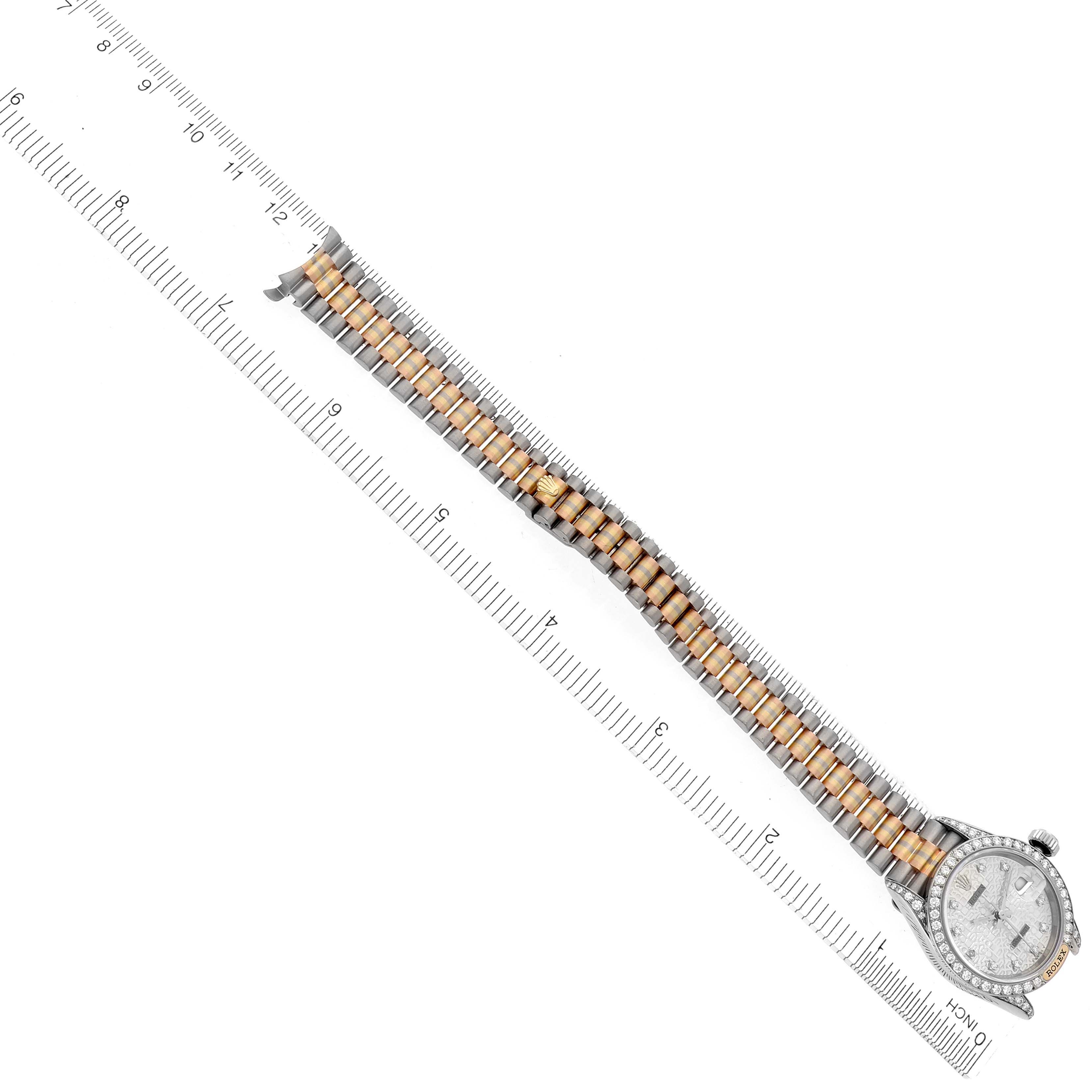 The Rolex President 69159 Women's White Gold Silver Dial 69159 Women's White Gold Silver Dial model watch is shown from above, highlighting its band and face alongside a ruler for scale.