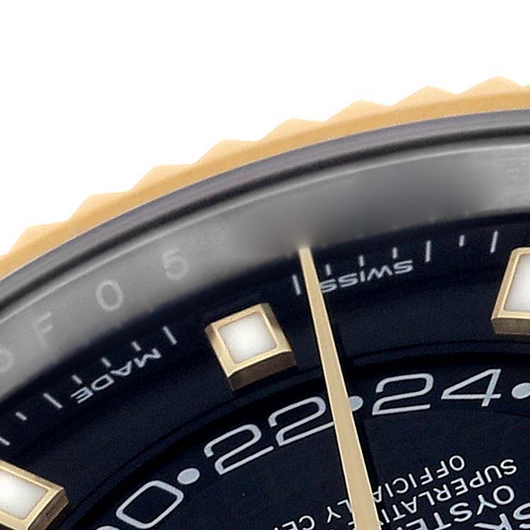 This image shows a close-up of the dial and bezel of a Rolex Sky-Dweller 326933 Men's Steel and Gold (two tone) Black Dial 326933 Men's Steel and Gold (two tone) Black Dial watch with parts of the indices, hands, and markers visible.
