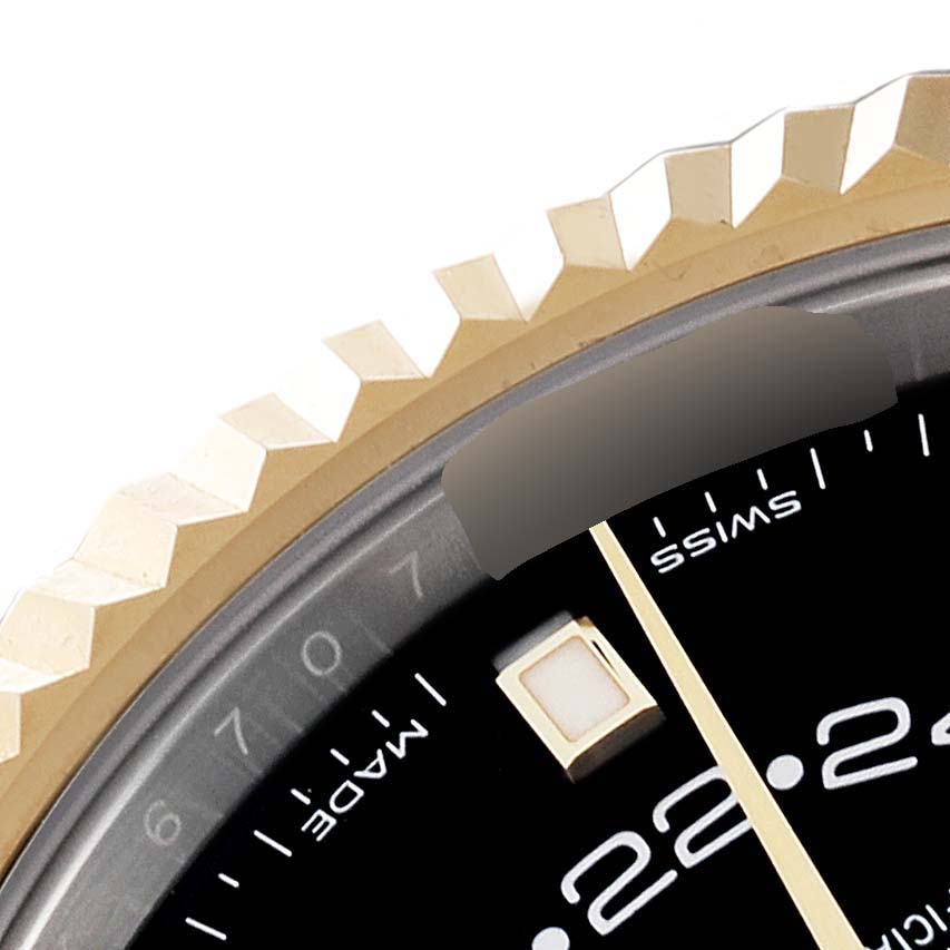 This image shows a close-up of the bezel and part of the dial of a Rolex Sky-Dweller 326933 Men's Steel and Gold (two tone) Black Dial 326933 Men's Steel and Gold (two tone) Black Dial watch.