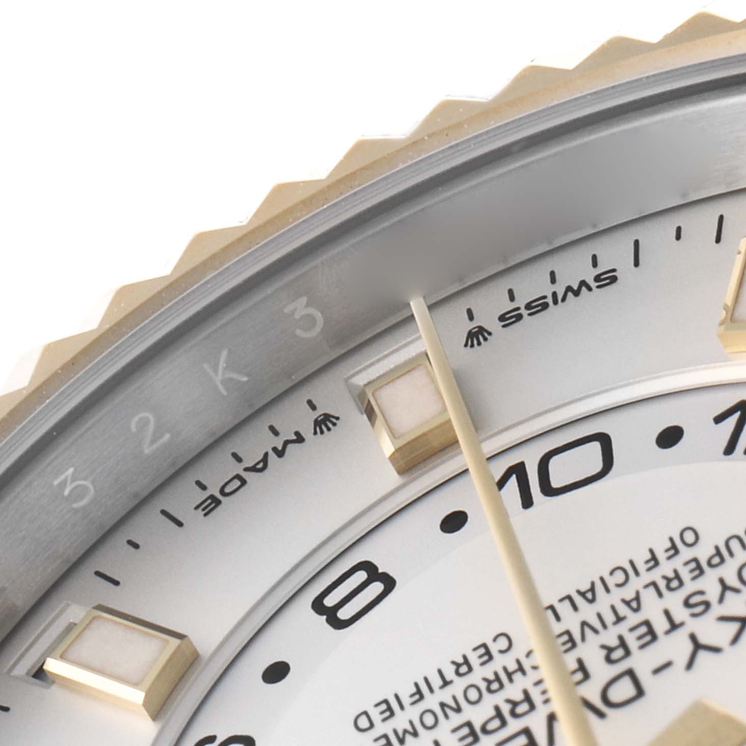 The image shows a close-up view of the dial and bezel details of a Rolex Sky-Dweller 336933 Men's Steel and Gold (two tone) Silver Dial, focusing on the indices and markings.