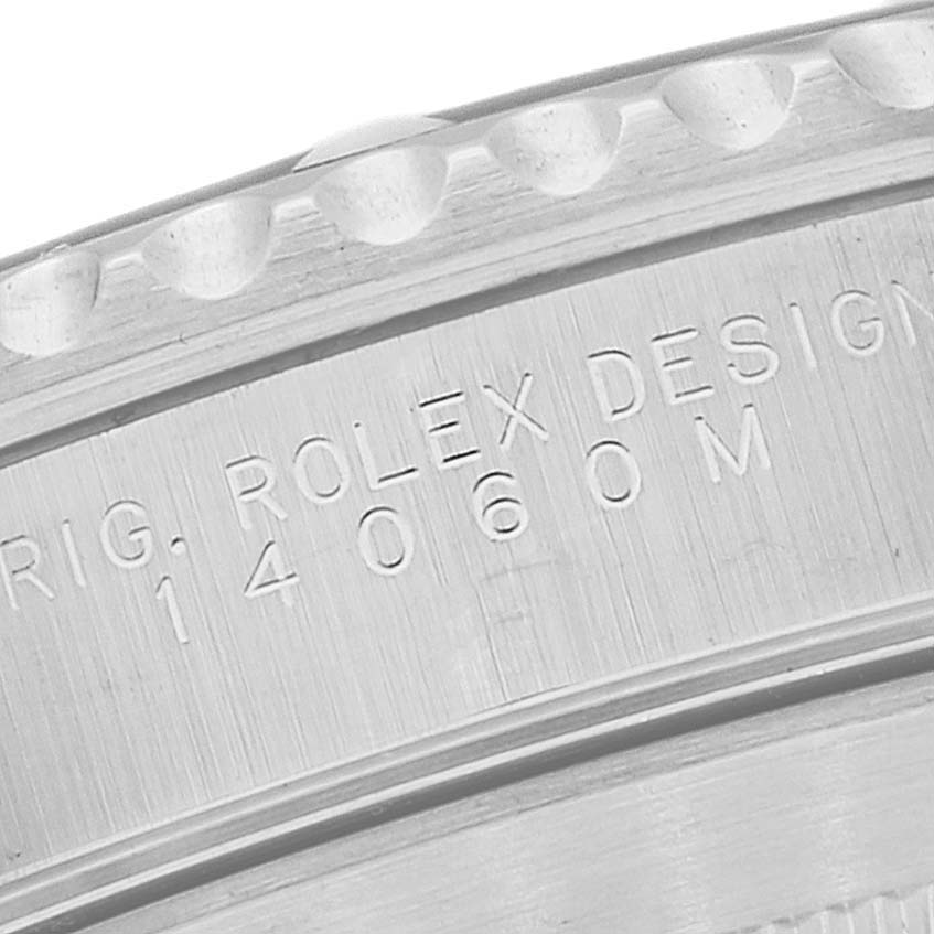 This image shows a close-up of the engraved bezel and case side of the Rolex Submariner 14060M Men
s Stainless Steel Black Dial 14060M Men
s Stainless Steel Black Dial model.