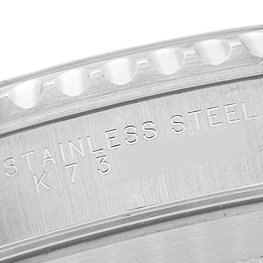 The image shows a close-up angle of the bezel and case back of a Rolex Submariner 14060M Men
s Stainless Steel Black Dial 14060M Men
s Stainless Steel Black Dial, highlighting the "STAINLESS STEEL" engraving.