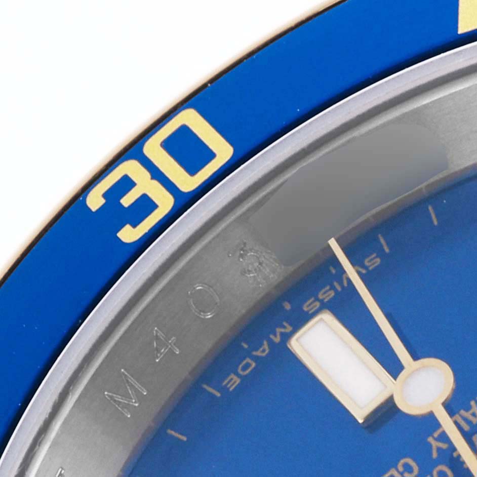 The image shows a close-up of the bezel, edge of the dial, and part of the minute hand of a Rolex Submariner 16613LB Men's Steel and Gold (two tone) Blue Dial 16613LB Men's Steel and Gold (two tone) Blue Dial.