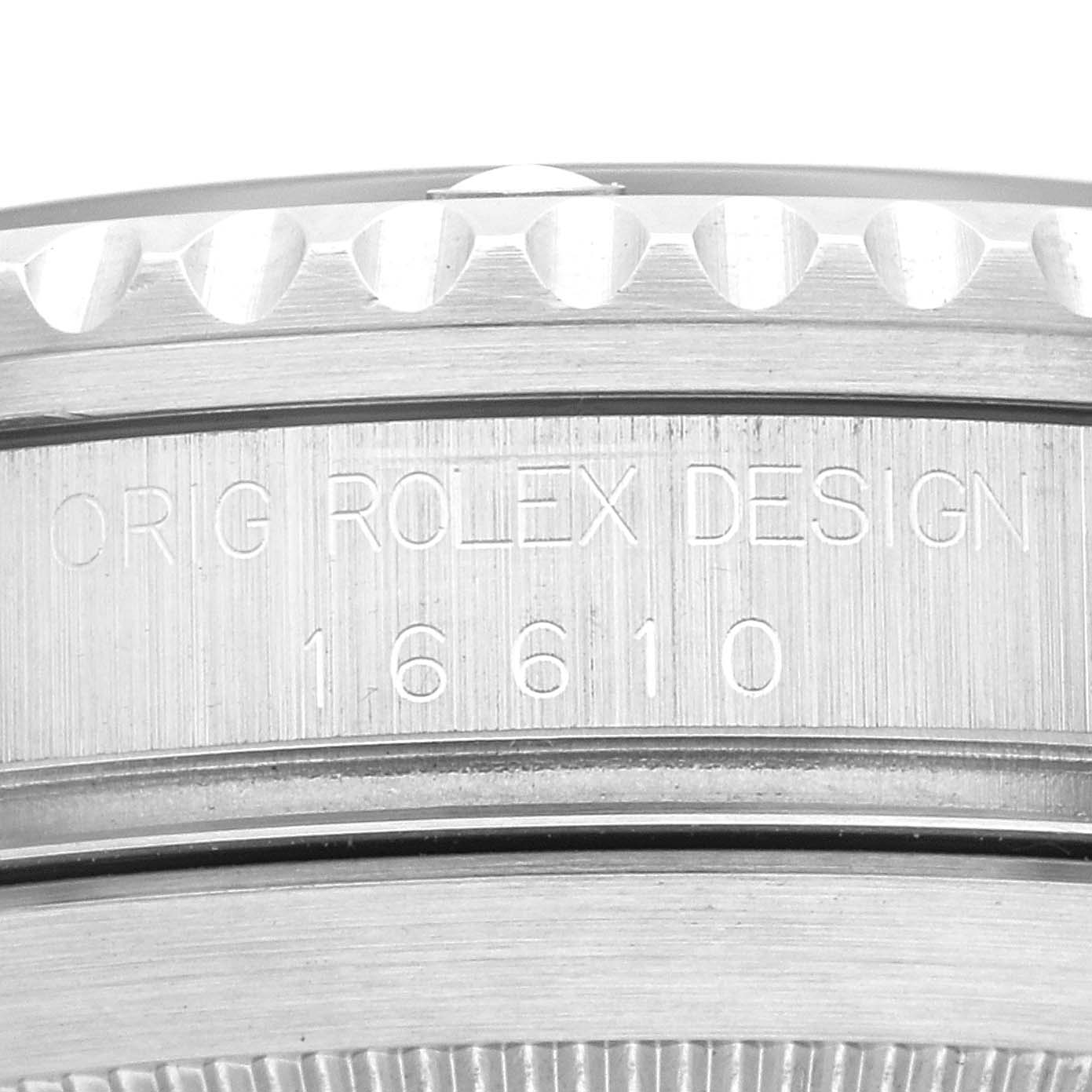 The image shows a close-up view of the side casing of a Rolex Submariner 16610 Men
s Stainless Steel Black Dial 16610 Men
s Stainless Steel Black Dial watch, displaying the engravings "ORIG ROLEX DESIGN 16610".