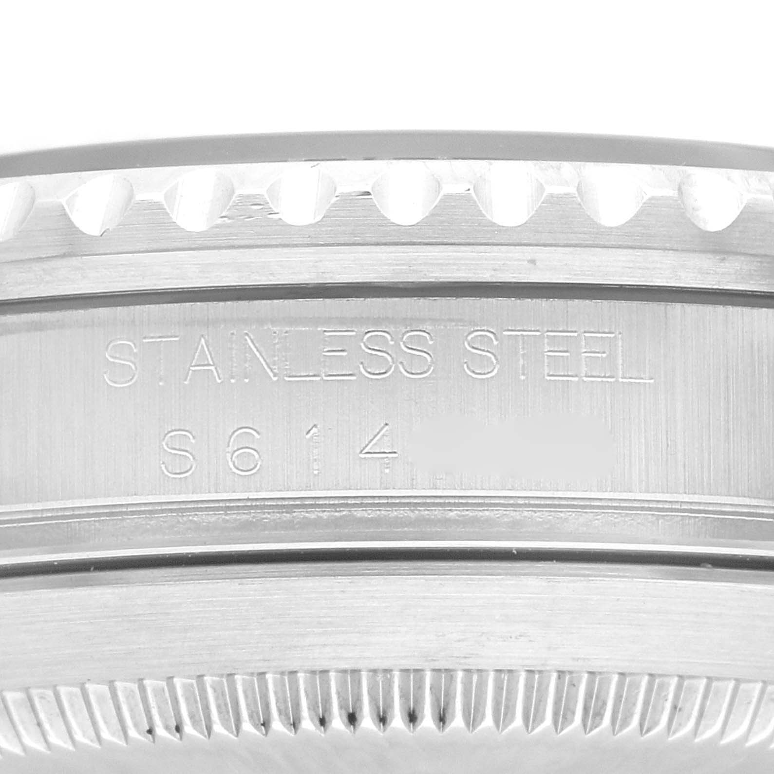 This image shows a close-up of the case back and the edge of the bezel of a Rolex Submariner 16610 Men
s Stainless Steel Black Dial 16610 Men
s Stainless Steel Black Dial watch, displaying the "STAINLESS STEEL" engraving.