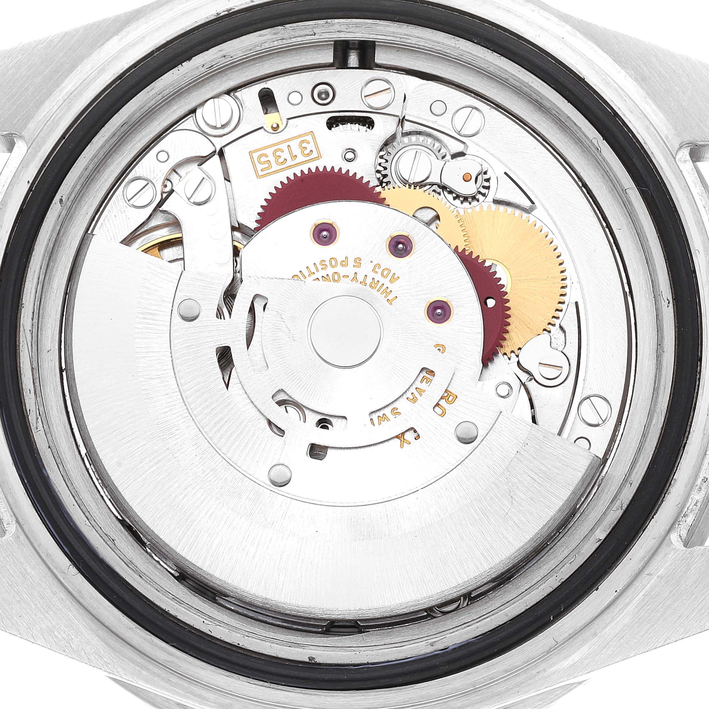 This image shows the internal mechanical movement of a Rolex Submariner 16610LV Men's Stainless Steel Black Dial 16610LV Men's Stainless Steel Black Dial watch from a rear angle, displaying gears and components.