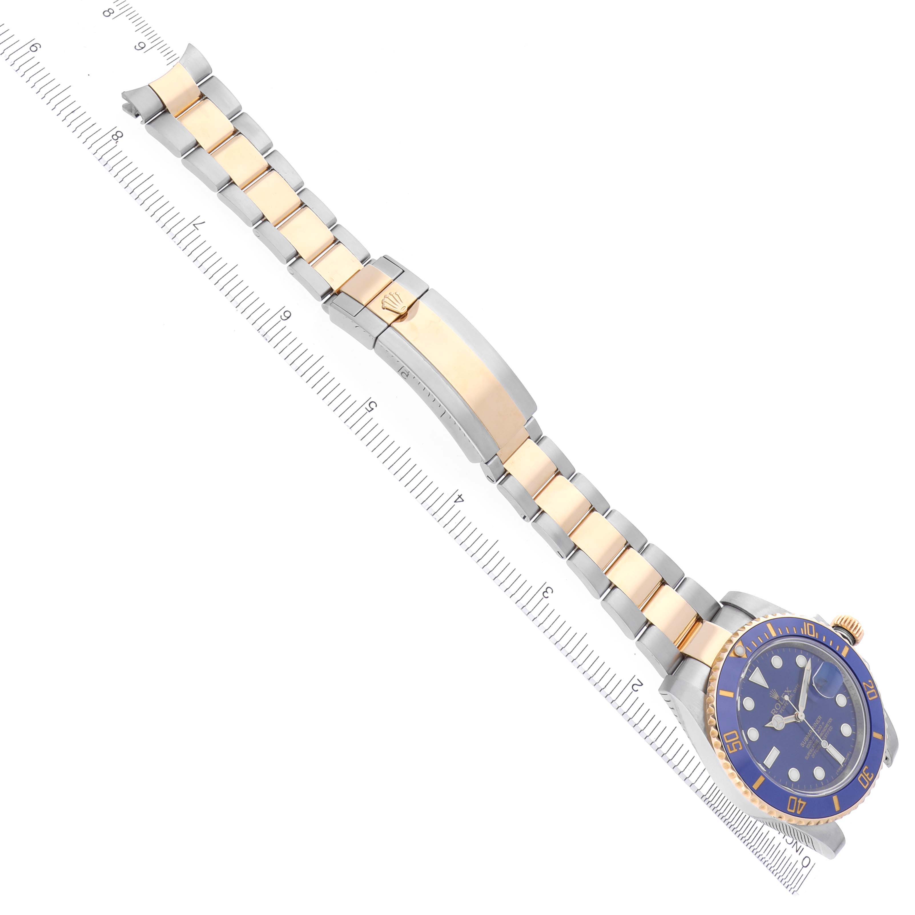 The Rolex Submariner 116613LB Men's Steel and Gold (two tone) Blue Dial 116613LB Men's Steel and Gold (two tone) Blue Dial watch is shown from an angled top view, depicting the face, bezel, strap, and clasp.